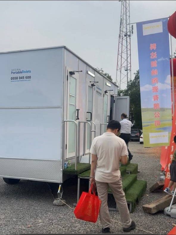 Guests using an Accra Portable Toilets trailer at an outdoor event